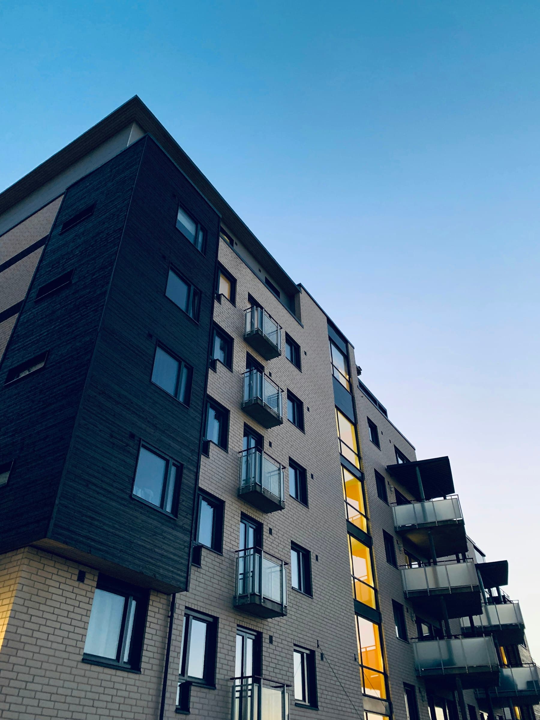 Dark-clad apartment block at dusk